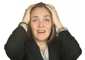 astonished business woman with hands on head